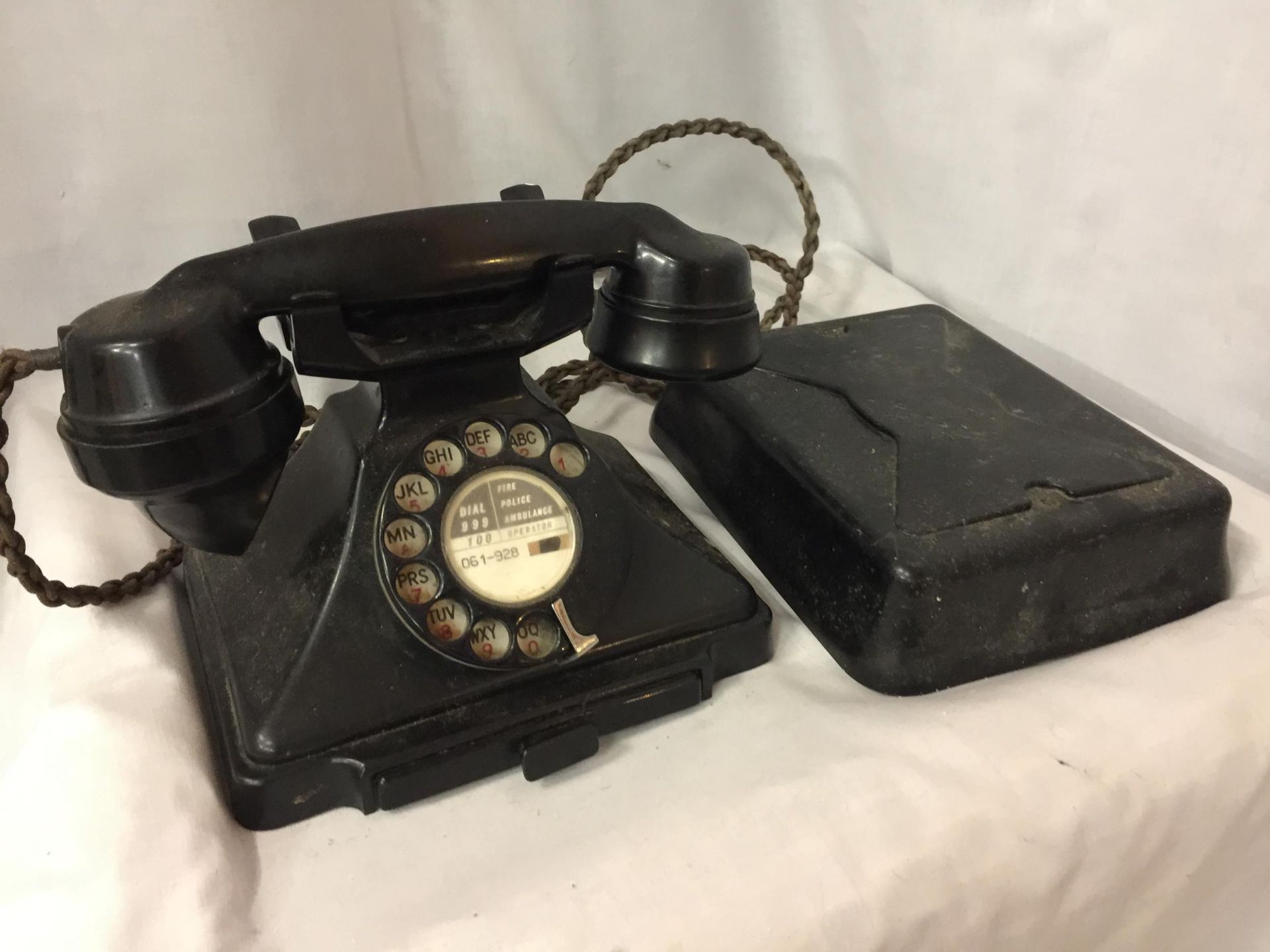 A VINTAGE ROTARY DIAL BLACK BAKELITE G.P.O. TELEPHONE 1/232CB FWR55/2 TOGETHER WITH WALL MOUNTED BOX