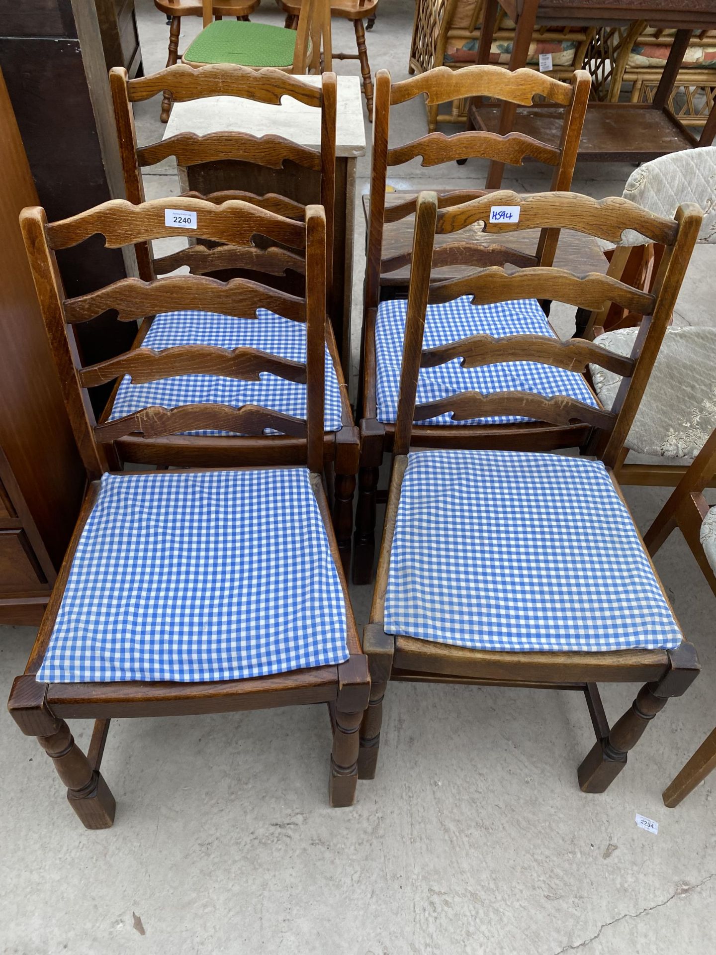 A SET OF FOUR MODERN LADDERBACK DINING CHAIRS