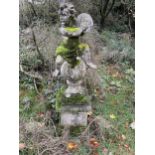 A RECONSTITUTED STONE STATUE OF A CHERUB SEATED ON A BALL (H:149CM)