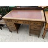 AN EDWARDIAN OAK TWIN PEDESTAL DESK ENCLOSING SEVEN DRAWERS, 48 X 27"