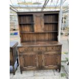 AN OAK JACOBEAN STYLE DRESSER WITH PLATE RACK, 50" WIDE