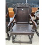 A 17TH CENTURY OAK JOINED ELBOW CHAIR WITH CARVED TOP RAIL AND TURNED FRONT LEGS