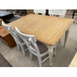 A MODERN OAK AND PAINTED DINING TABLE AND FOUR DINING CHAIRS