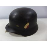 A NAZI GERMANY BLACK PAINTED HELMET WITH BLACK, WHITE AND RED DECAL, LEATHER LINING
