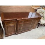 A GEORGIAN STYLE MAHOGANY AND CROSSBANDED BREAK FRONT SIDEBOARD HAVING SIX DRAWERS AND TWO CUPBOARDS