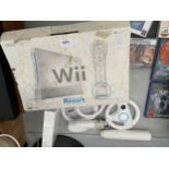 A NINTENDO WII WITH VARIOUS ACCESORIES