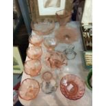 A QUANTITY OF ROSE COLOURED GLASSWARE TO INCLUDE VARIOUS SIZES OF BOWLS, CANDLESTICKS, ETC