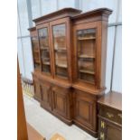 A VICTORIAN OAK BREAKFRONT BOOKCASE ON BASE, WITH FOUR CUPBOARDS TO THE BASE, 96" WIDE