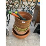 AN ASSORTMENT OF TERACOTTA PLANT POTS AND GARDEN TOOLS