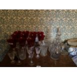 A LARGE COLLECTION OF GLASSWARE TO INCLUDE ELEVEN RED WINE GLASSES, DECANTERS ETC