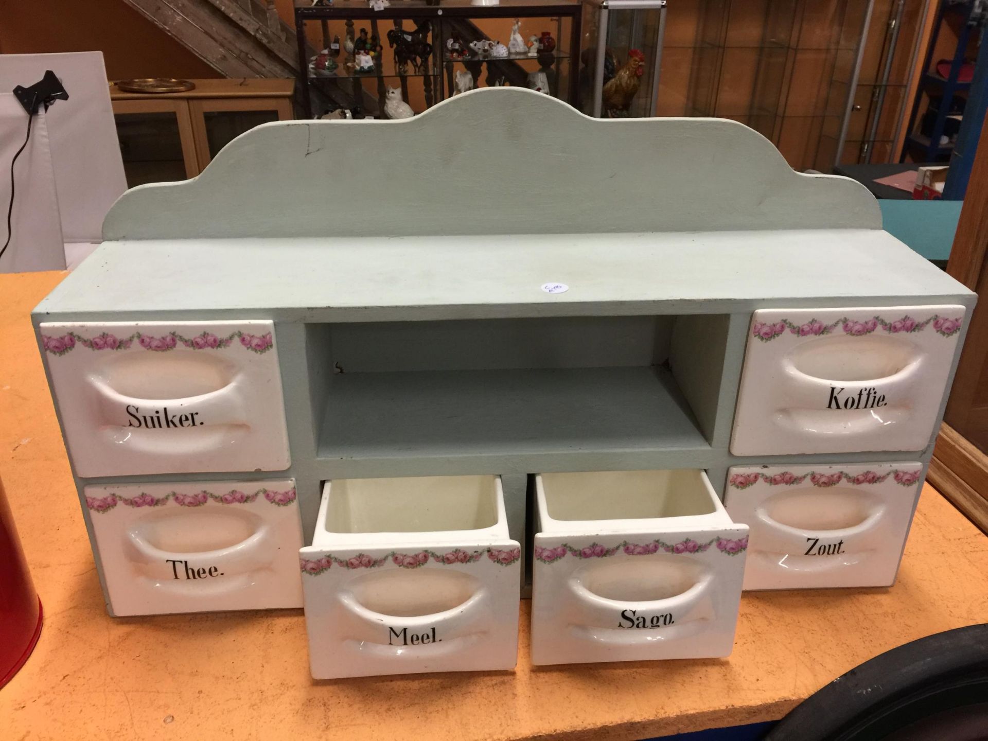 A DUTCH KITCHEN SET OF SIX PORCELAIN CONDIMENT DRAWERS IN WOODEN FRAME