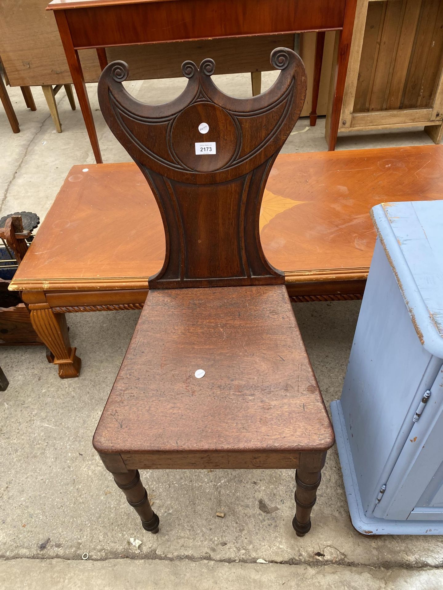 A 19TH CENTURY MAHOGANY HALL CHAIR WITH CRESCENT SHAPED TOP