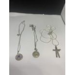 THREE SILVER NECKLACES WITH PENDANTS TO INCLUDE TWO CROSSES, A FLOWER DESIGN AND COIN