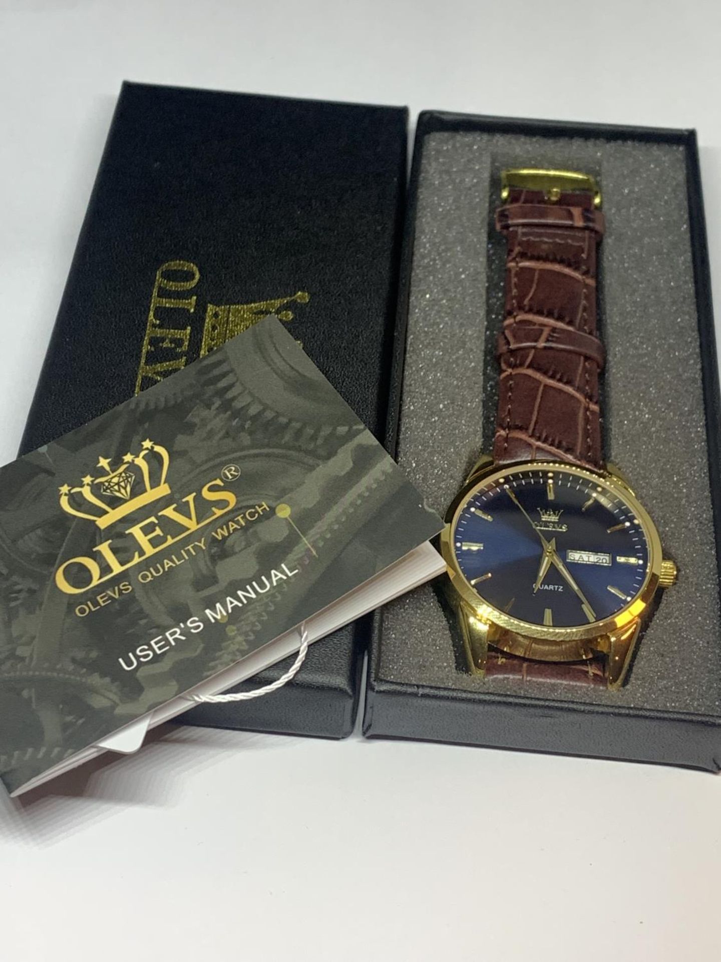 AN AS NEW AND BOXED OLEVS WRIST WATCH SEEN WORKING BUT NO WARRANTY