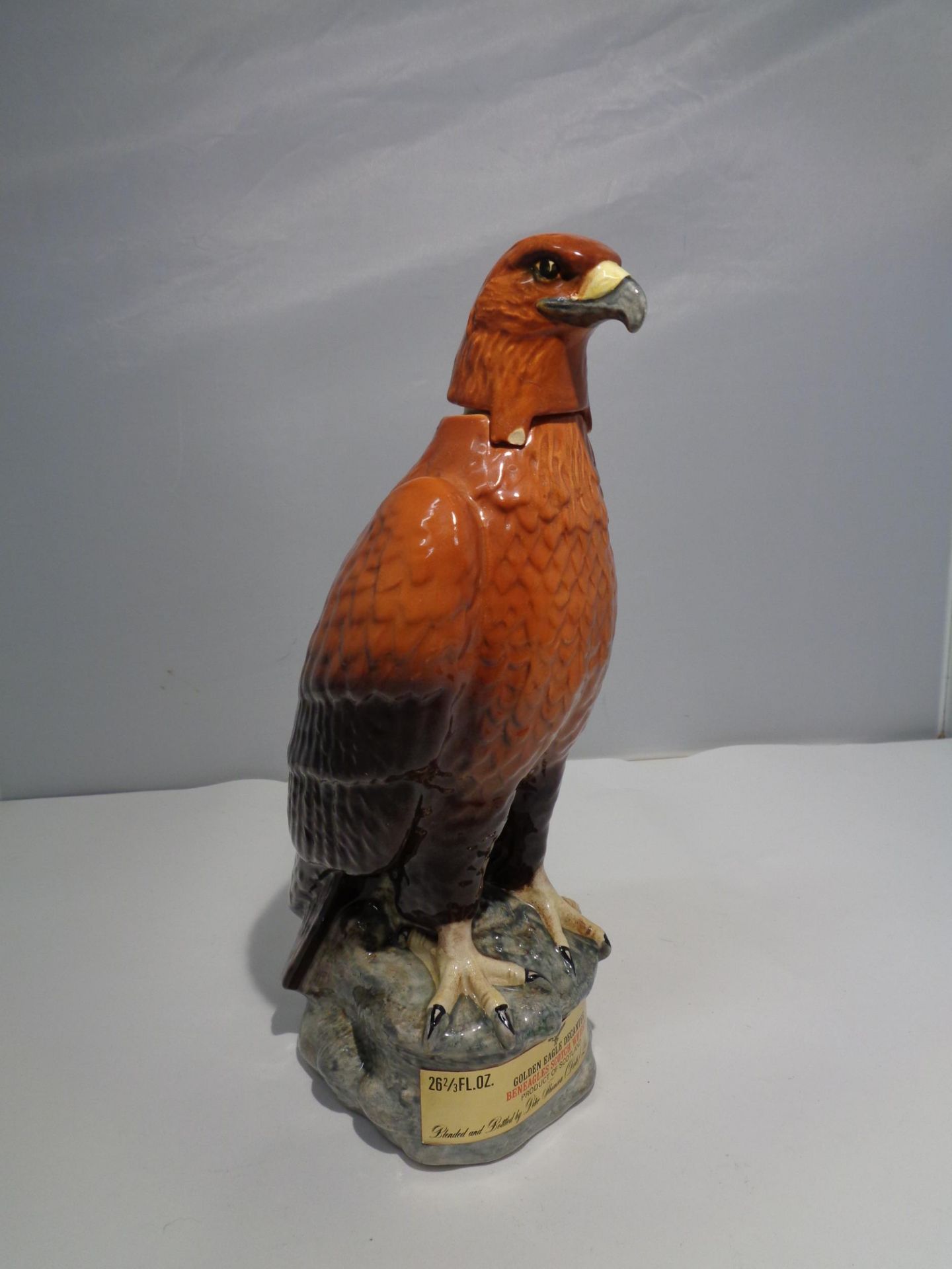 A CERAMIC BENEAGLES SCOTCH WHISKEY DECANTER IN THE DESIGN OF A GOLDEN EAGLE A/F