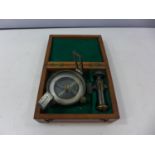 A CASED COMPASS AND STAND ATTACHMENTS, FACE DIAMETER 8CM