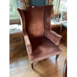 AN EDWARDIAN MAHOGANY FRAMED WING BACK ARMCHAIR UPHOLSTERED IN DARK PINK MATERIAL TOGETHER WITH