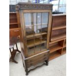 AN EARLY 20TH CENTURY OAK GLAZED CABINET WITH TWO DRAWERS, ON OPEN BASE, 28" WIDE
