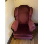 A WING BACK ARMCHAIR ON CABRIOLE SUPPORTS