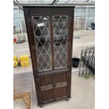 AN OAK GLAZED AND LEADED CORNER CABINET