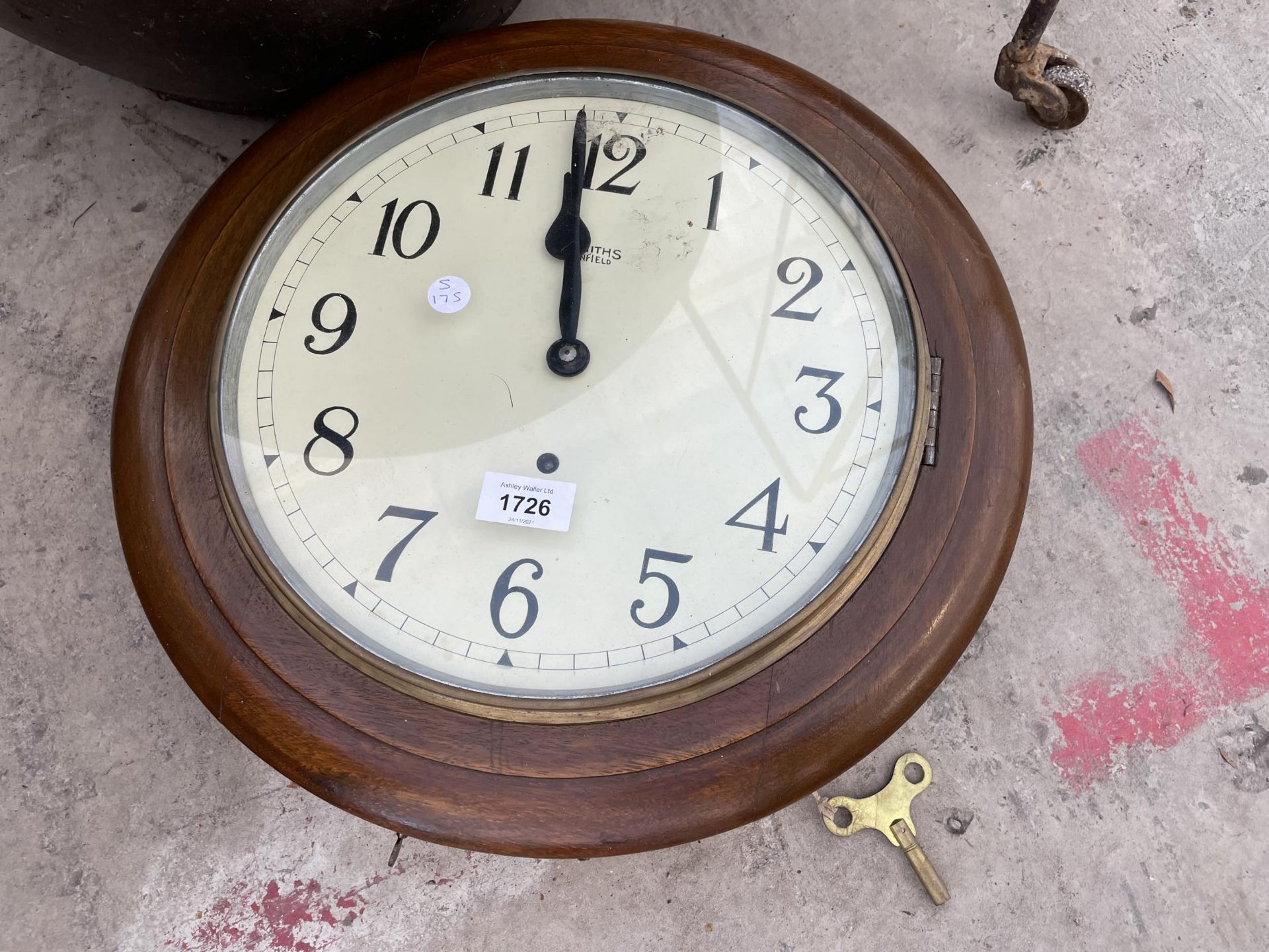 A WOODEN CASED CIRCULAR WALL CLOCK