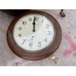 A WOODEN CASED CIRCULAR WALL CLOCK