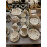 A LARGE AMOUNT OF CHINA DINNERWARE TO INCLUDE CUPS, SAUCERS, PLATES, TEAPOTS, BOWLS, ETC