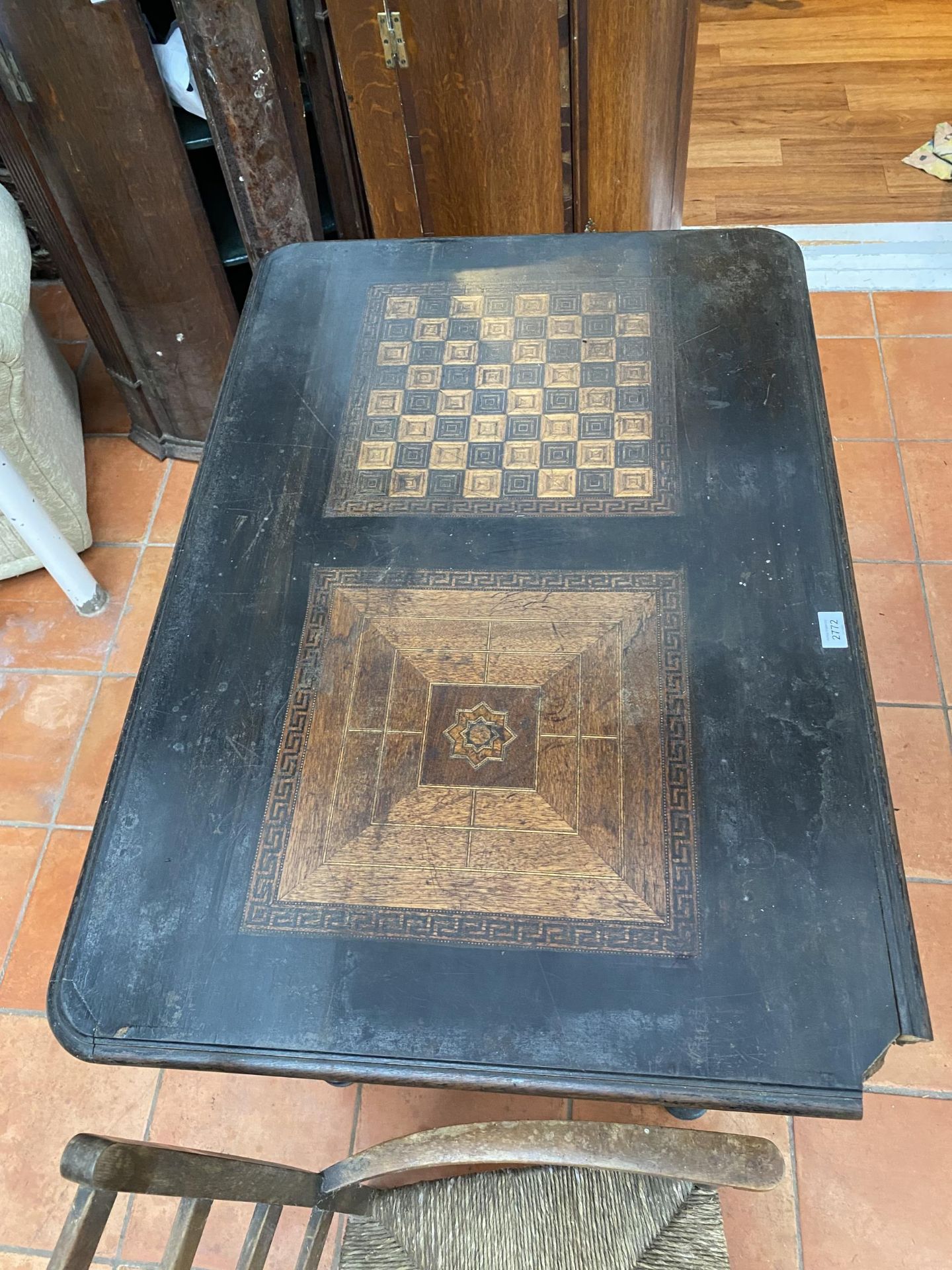 A VICTORIAN EBONISED GAMES TABLE WITH CHESS BOARD TOP AND TWO DRAWERS ON CARVED SUPPORTS 100CM X - Image 2 of 5