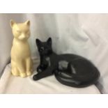 TWO LARGE CAT FIGURES, ONE BLACK, LYING DOWN, LENGTH 36CM, AND A CREAM ONE, HEIGHT 30CM