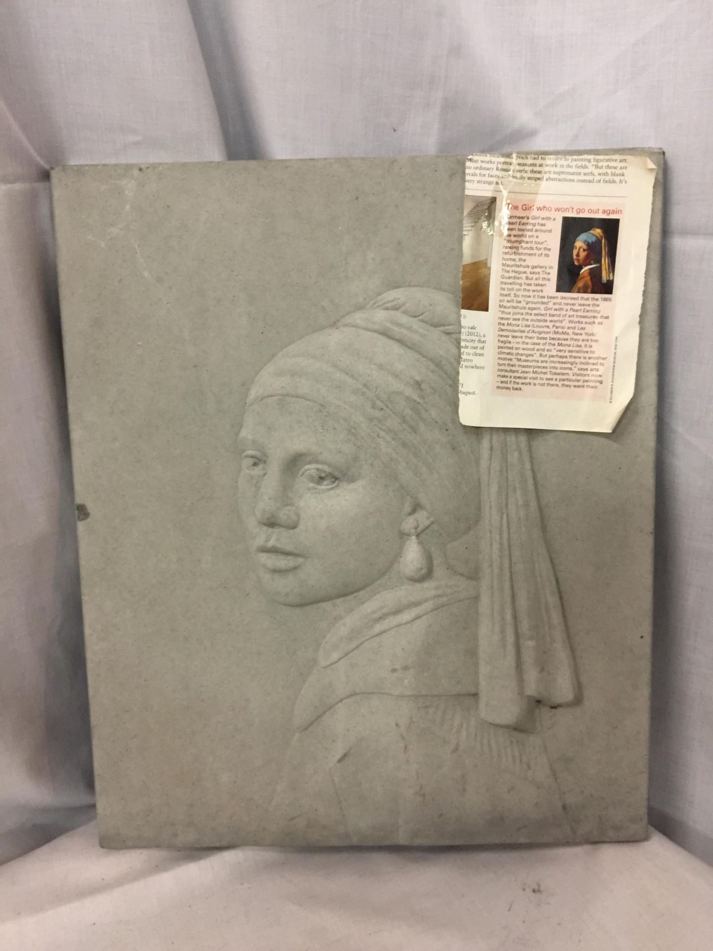 A CONSTITUTED STONE PLAQUE OF 'THE GIRL WHO WON'T GO OUT AGAIN', 40CM X 33CM