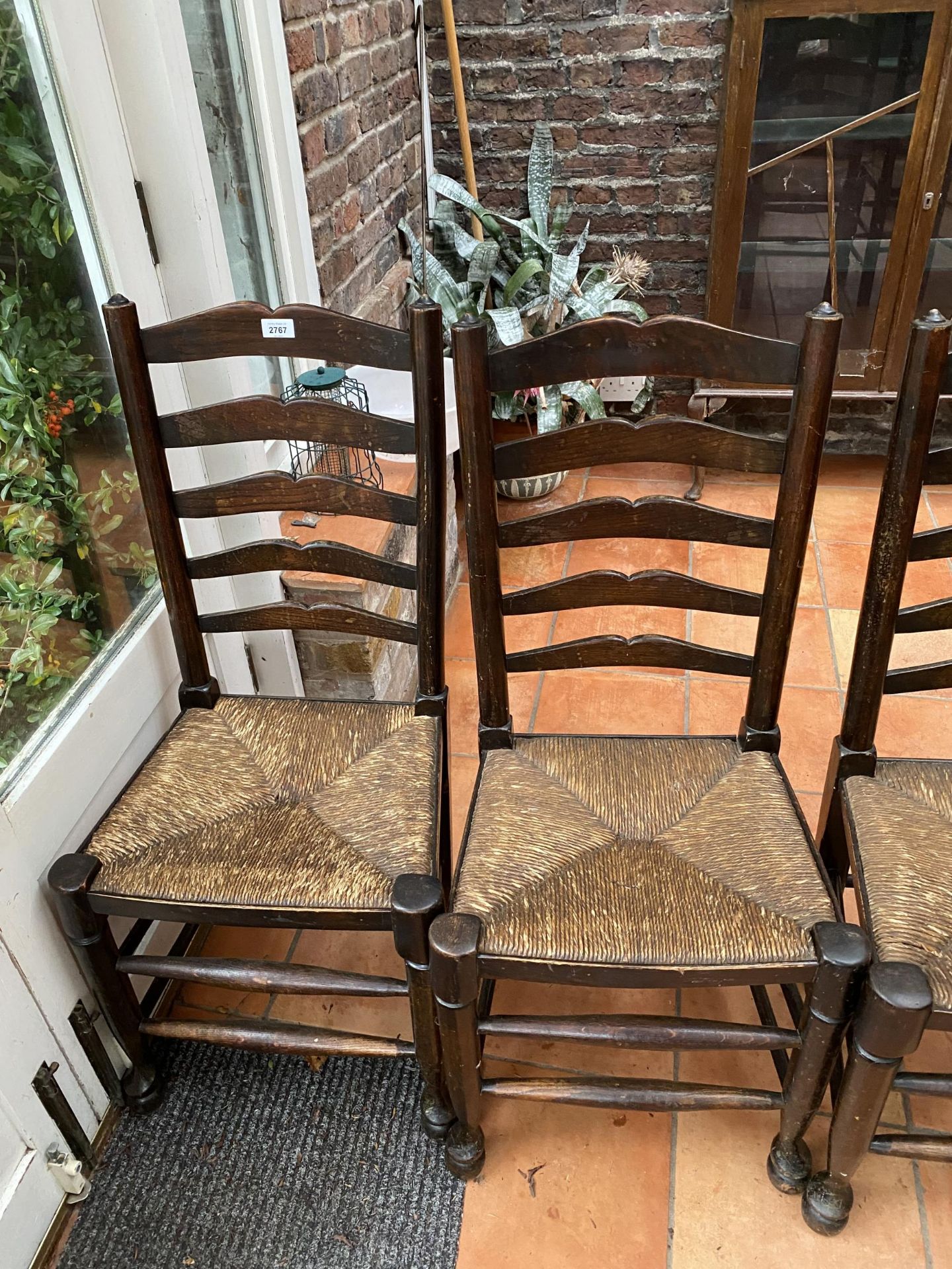A SET OF FOUR LANCASHIRE STYLE OAK LADDER BACK DINING CHAIRS WITH RUSH SEATS - Image 2 of 4