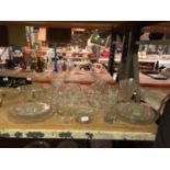 A LARGE QUANTITY OF CLEAR GLASSWARE TO INCLUDE A DECO STYLE VASE, CAKE STANDS, EGG CUPS, PLATES,