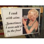 A TIN PLATE SIGN SAYING I COOK WITH WINE. SOMETIMES I EVEN ADD IT TO THE FOOD