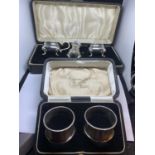A PAIR OF HALLMARKED BIRMINGHAM NAPKIN RINGS AND A SILVER PLATED CRUET SET (NO SPOON) BOTH IN