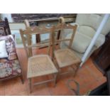 A PAIR OF CARVED BEECHWOOD CHAIRS WITH CANE SEATS, TOWEL RAIL AND TWO LABRADOR CUSHIONS