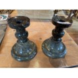 A PAIR OF POLISHED PURBECK STONE CANDLESTICKS A/F H - 15CM