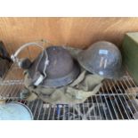 TWO VINTAGE MILITARY HELMETS, A SET OF HEAD PHONES AND A SATCHEL