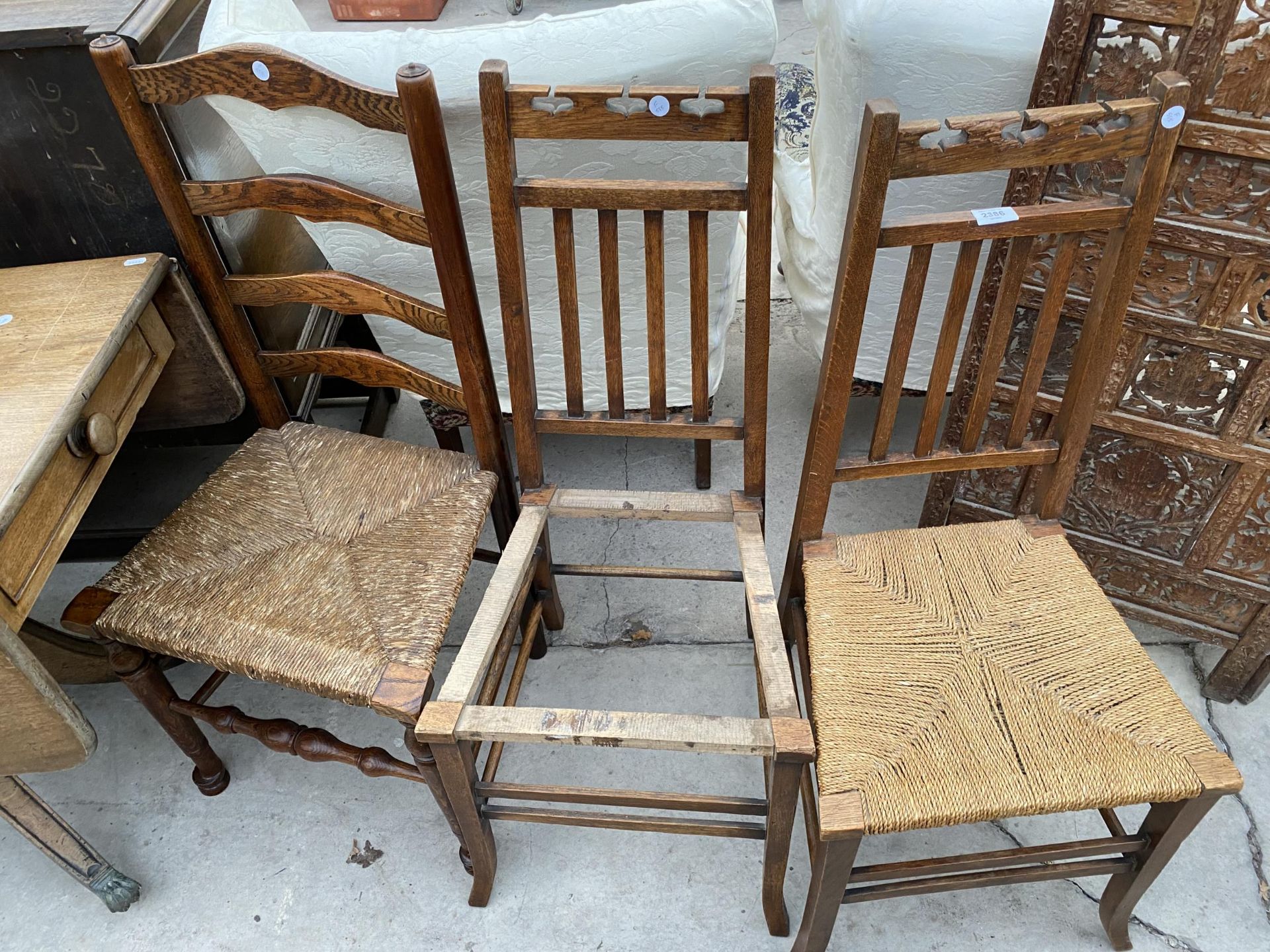 A PAIR OF OAK ARTS & CRAFTS BEDROOM CHAIRS AND LANCASHIRE LADDERBACK CHAIR