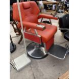 A MODERN ADJUSTABLE BARBERS CHAIR IN VIVID ORANGE