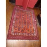 A SMALL CAUCASIAN RUG OF MAINLY RED GROUND 166CM X 123CM