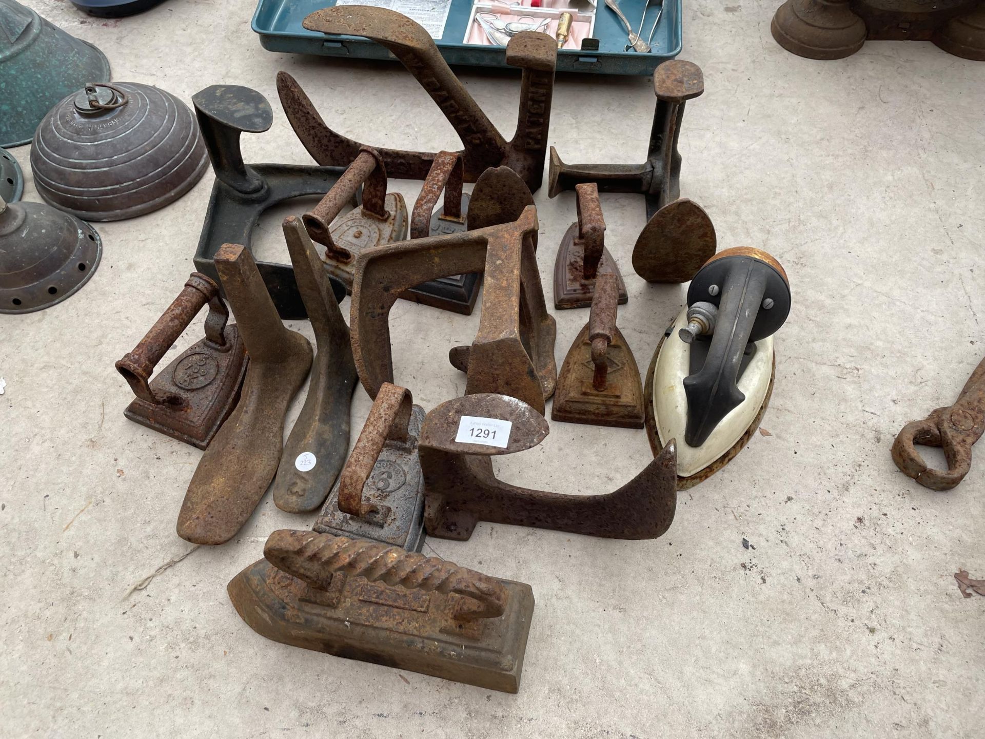 AN ASSORTMENT OF VINTAGE COBBLERS LASTS AND FLAT IRONS ETC