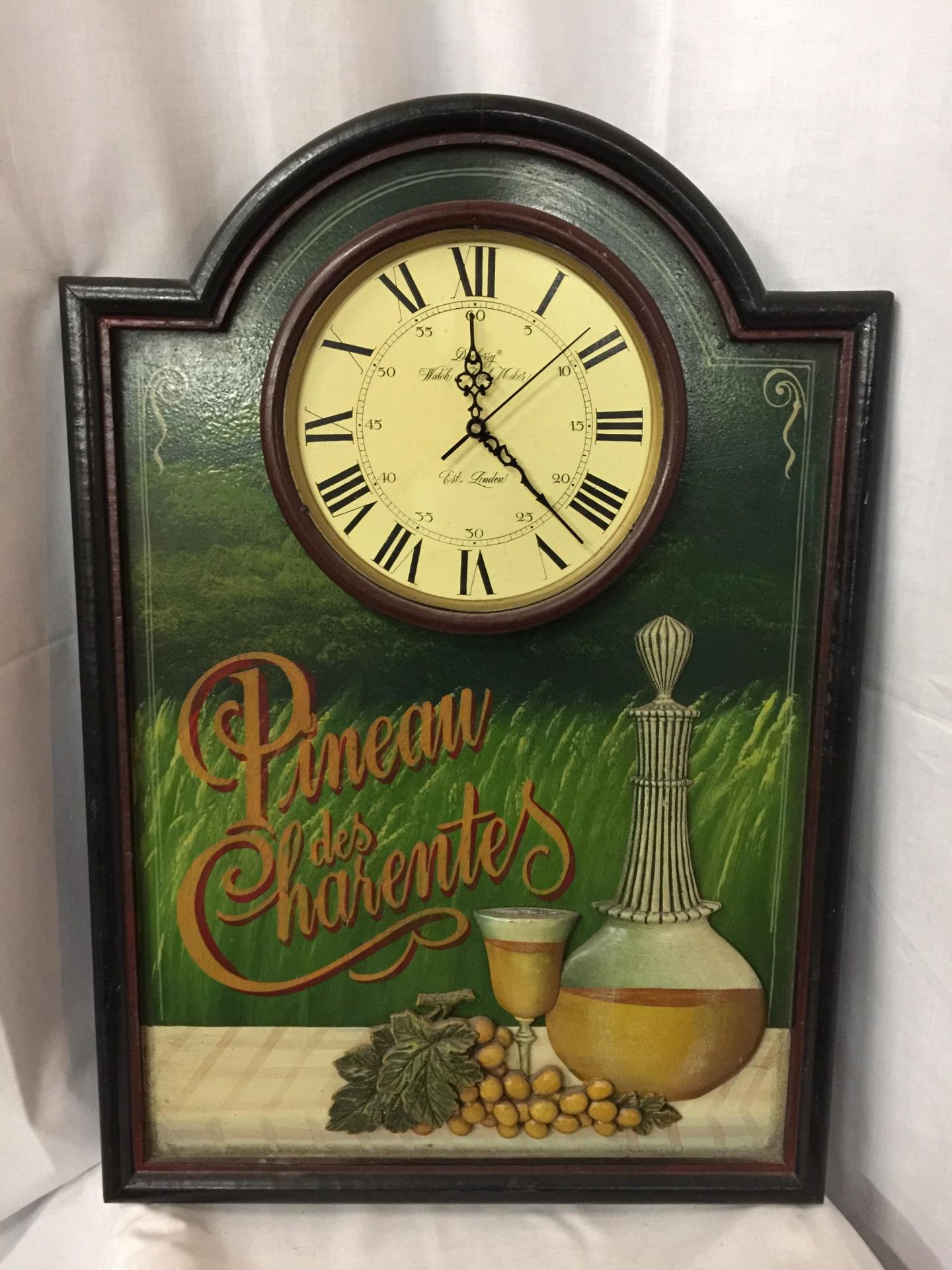 A PINEAU DES CHARENTES ADVERTISING BOARD WITH CLOCK