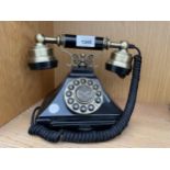 A BLACK AND BRASS PUSH BUTTON TELEPHONE WITH SLIDE OUT CARD TRAY