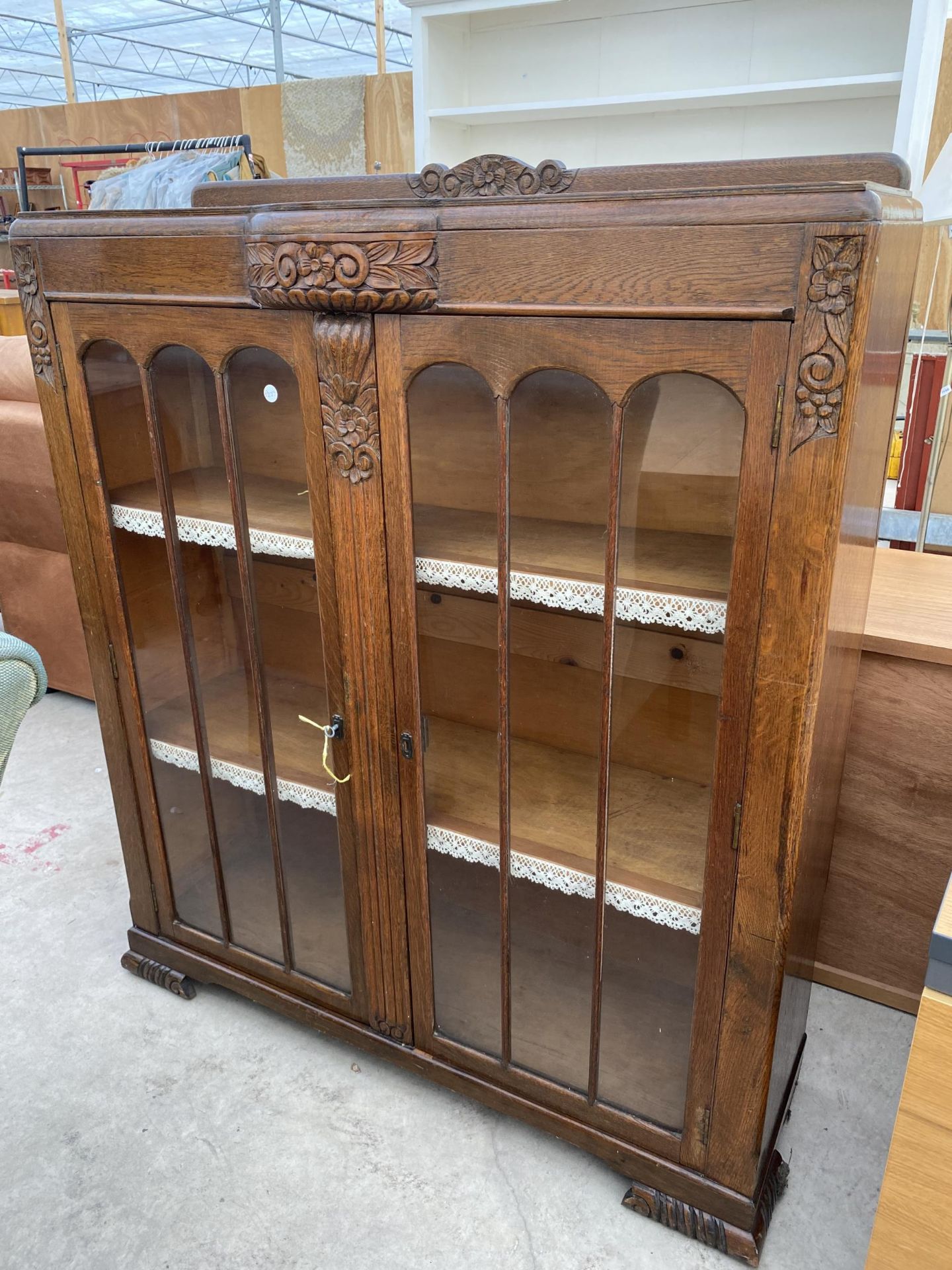 AN EARLY 20TH CENTURY OAK TWO DOOR DISPLAY CABINET, 40" WIDE