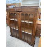 AN EARLY 20TH CENTURY OAK TWO DOOR DISPLAY CABINET, 40" WIDE