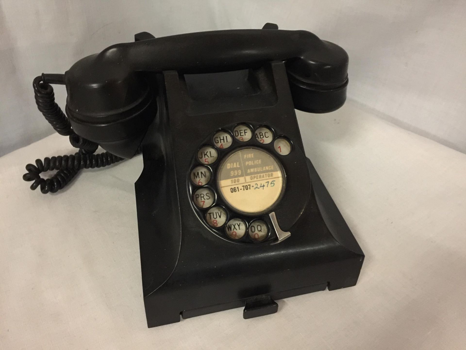 A VINTAGE BLACK 1950'S BAKELITE GPO ROTARY DIAL TELEPHONE WITH PULL OUT CARD TRAY