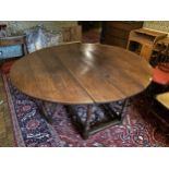 A SUBSTANTIAL EARLY 19TH CENTURY OAK GATE LEG DINING TABLE ON TURNED SUPPORTS 169 CM X 184 CM