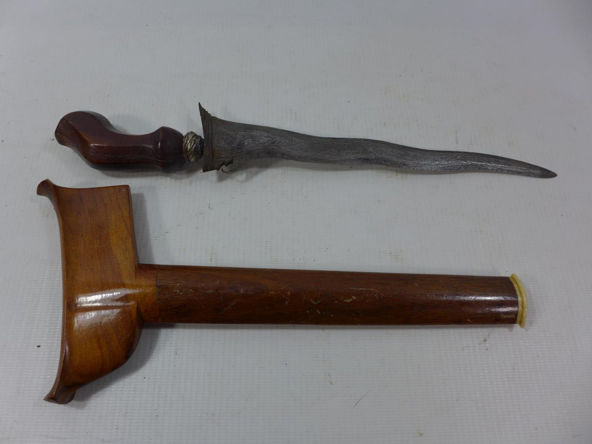 A BALANISE KRIS, 21CM WAVY BLADE, WOODEN GRIP AND SCABBARD