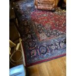 A LARGE RED GROUND CARPET WITH BLUE FLORAL SURROUND 315CM C 406CM AND A SMALL RED GROUND RUG 130CM X