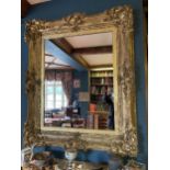 A SUBSTANTIAL ORNATE GILT FRAMED MIRROR 124CM X 103CM